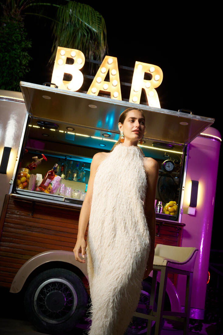 Guest standing at the bar cart at night at Belek Beach Resort