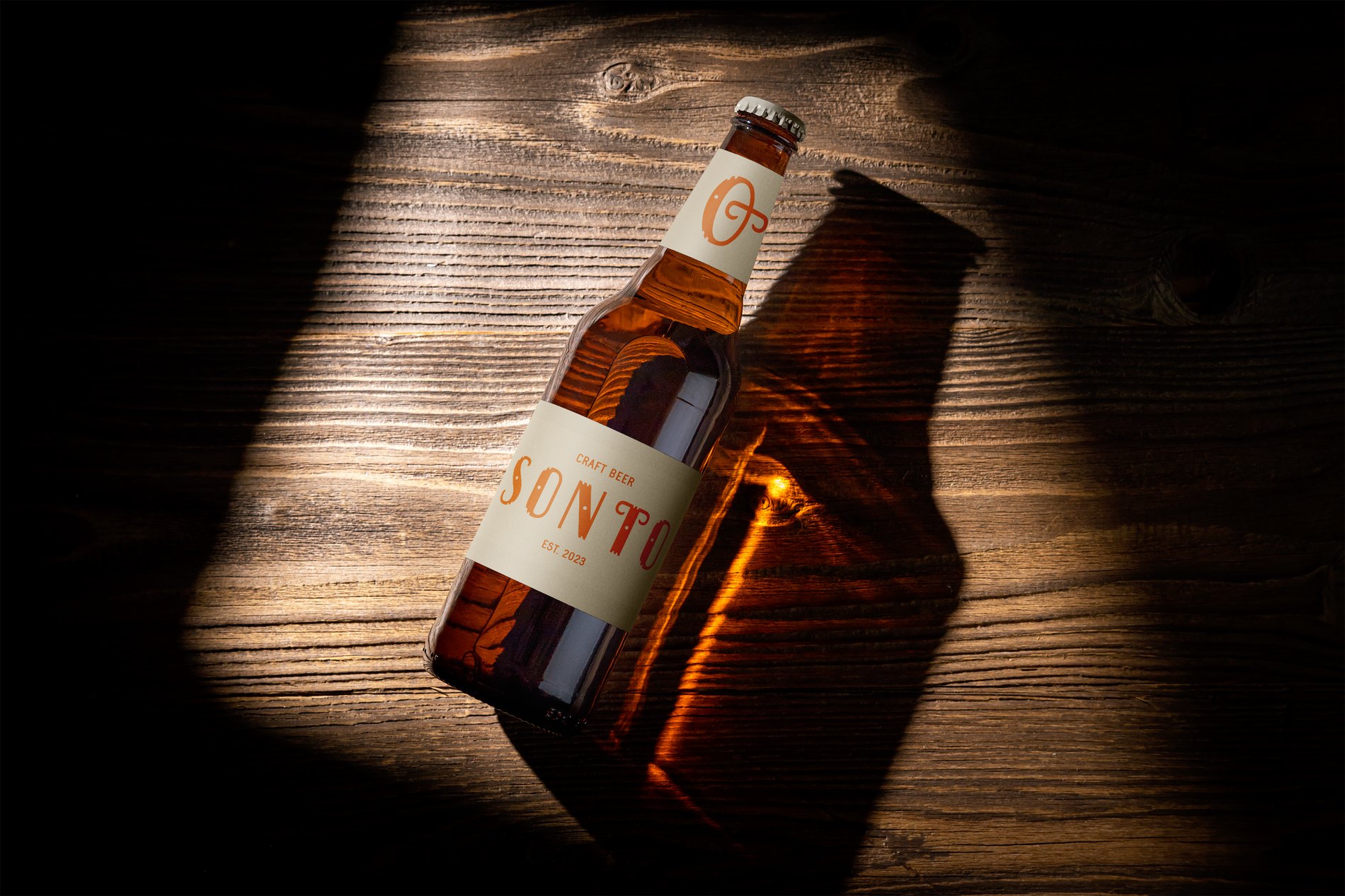 Sonto Beer original bottle design — dramatic light on a wooden surface