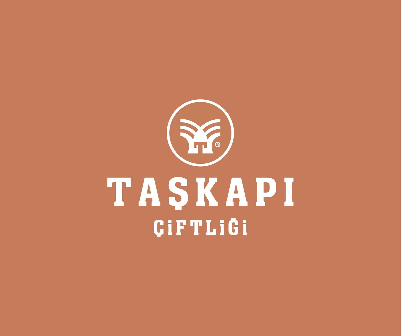 Taşkapı Çiftliği monogram and wordmark, reversed in white on the brand's terracotta color